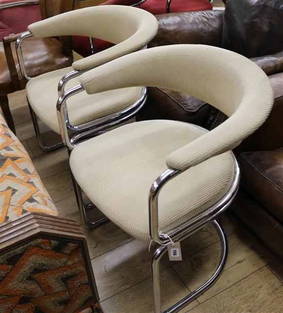 A pair of chrome and upholstered tub chairs
